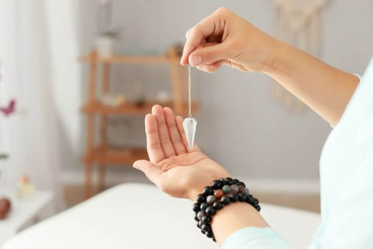 Hand Holding Pendulum for Energy Assessment in Healing